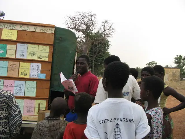 Picture - Reading and selling Nawdm books in a local market.JPG